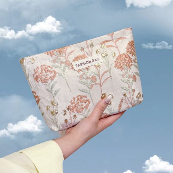 INS cream embroidery flower premium sense makeup bag large capacity water milk storage bag women's makeup portable clutch